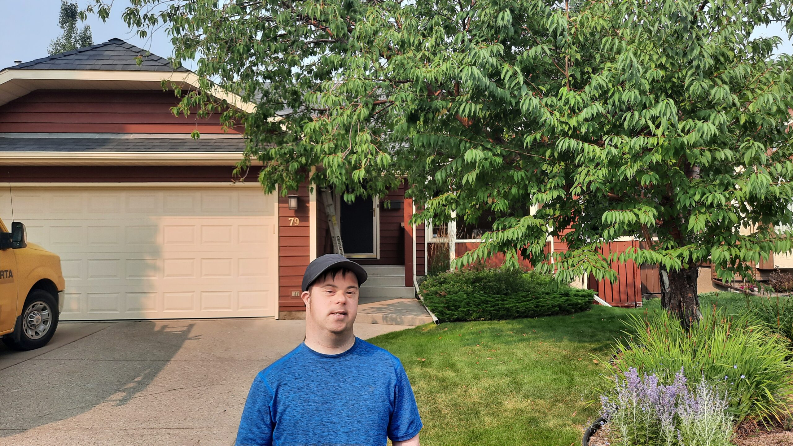 Paul stands in front of his childhood home.